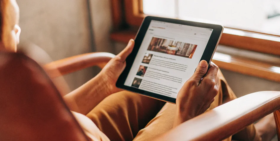 A person reading online reviews for a trustworthy casino website on a tablet.