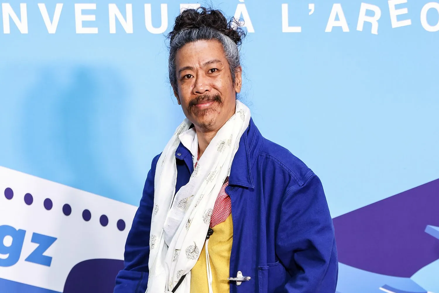 Bun Hay Mean performing stand-up comedy on stage during a live show