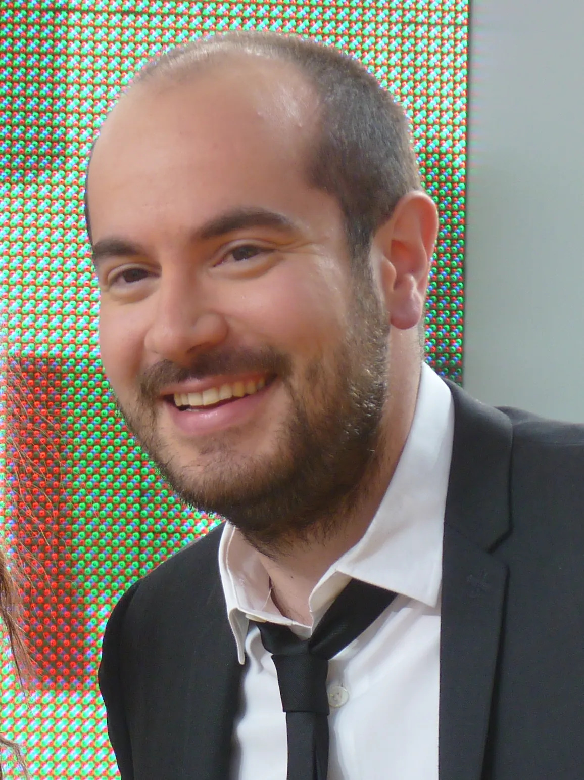 Kyan Khojandi performing stand-up comedy during a live show