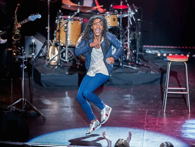 Shirley Souagnon delivering a stand-up comedy performance in front of a live audience